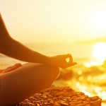 Hand Of  Woman Meditating In A Yoga Pose On Beach