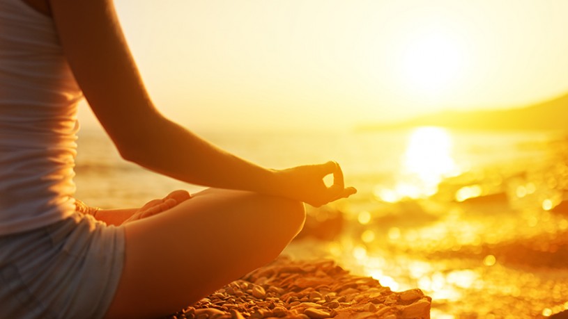 Hand Of  Woman Meditating In A Yoga Pose On Beach